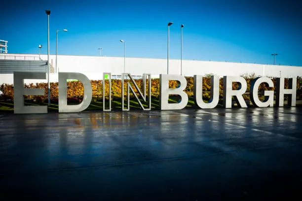 Large metal lettering at Edinburgh airport on clear sunny day